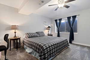Carpeted bedroom featuring baseboards, and ceiling fan