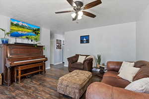 Living area with baseboards, a ceiling fan, and wood finished floors