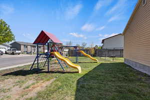 View of yard featuring a fenced backyard and a playground