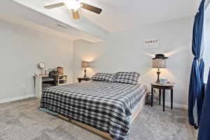 Carpeted bedroom featuring baseboards, and ceiling fan