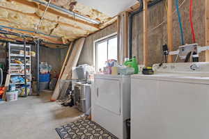 Storage area featuring washer and dryer
