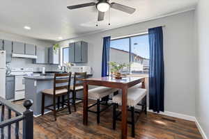 Dining space featuring ceiling fan, dark wood-type flooring, and recessed lighting