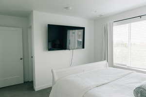 Carpeted bedroom with baseboards