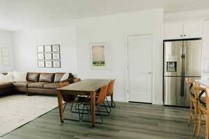Living room featuring baseboards and dark wood-style flooring