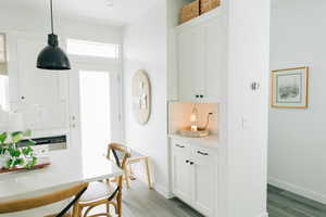 Interior space with baseboards and light wood-style floors