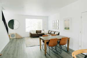 Dining space with baseboards and wood finished floors