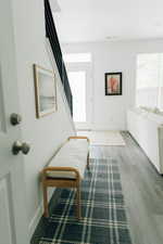 Foyer with baseboards, stairs, and wood finished floors