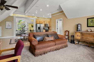 Carpeted living area with recessed lighting, ceiling fan, ornamental molding, and baseboards