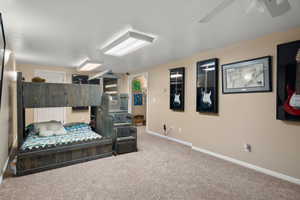 Bedroom featuring baseboards, carpet, and ceiling fan