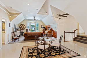 Dining room with crown molding, a ceiling fan, lofted ceiling, and visible vents