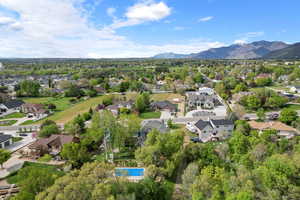 Birds eye view of property with a mountain view and a residential view