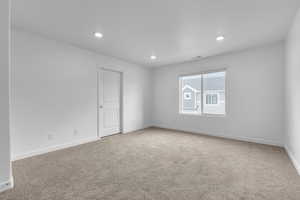 Unfurnished room with baseboards, carpet flooring, recessed lighting, and visible vents