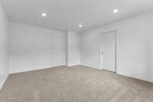 Spare room featuring baseboards, carpet flooring, and recessed lighting