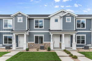 View of front of home featuring a front lawn and central AC