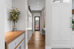 Corridor featuring wood-type flooring, recessed lighting, and baseboards