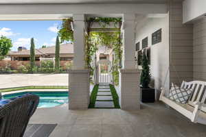 View of swimming pool featuring fence, a gate, and a swimming pool