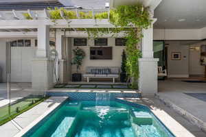 Pool featuring a patio area and a pergola