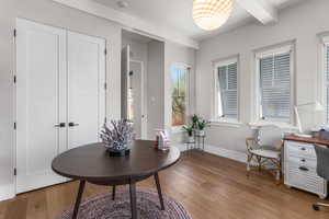Home office with beamed ceiling, baseboards, and light wood finished floors