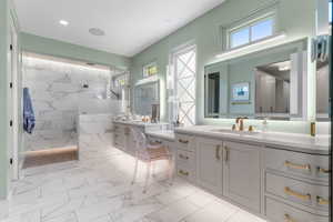 Full bath with a sink, a walk in shower, and marble finish floor