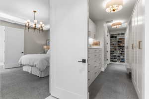 Interior space with an inviting chandelier, carpet floors, and visible vents