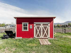 View of shed featuring a mountain view and fence
