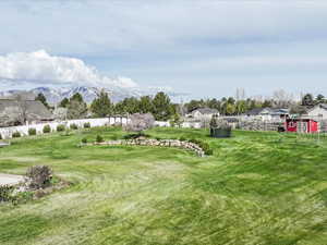 View of yard featuring fence and a mountain view