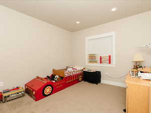 Carpeted bedroom with recessed lighting and baseboards