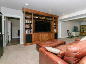 Living area with recessed lighting, baseboards, and light carpet