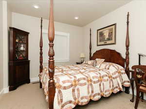 Bedroom with recessed lighting, baseboards, and light carpet