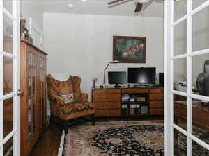 Office space with ceiling fan, french doors, and wood finished floors