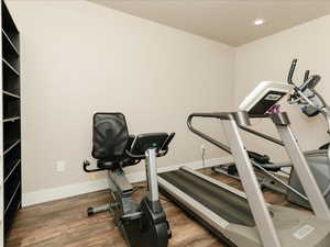Workout room with recessed lighting, baseboards, and wood finished floors
