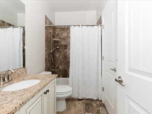 Full bath featuring vanity, toilet, and shower / tub combo