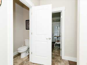 1/2 Bathroom, main floor, featuring baseboards and toilet