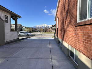 Exterior space featuring brick siding, a mountain view, and a residential view