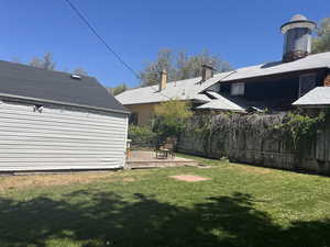 View of yard with fence and a deck