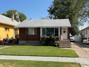 View of front of house with brick siding and a front yard
