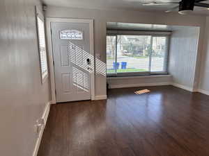 Entryway with plenty of natural light, baseboards, ceiling fan, and dark wood-style flooring