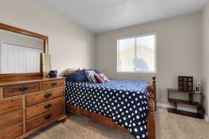 Bedroom featuring light colored carpet and baseboards