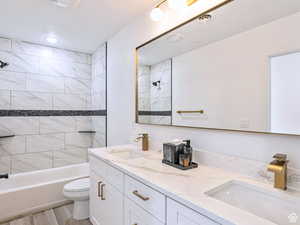 Full bath featuring shower / tub combination, a sink, a textured ceiling, and toilet