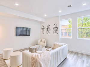 Living room with visible vents, recessed lighting, light wood finished floors, and baseboards