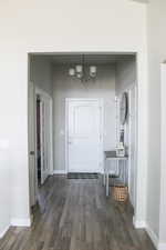 Entrance foyer featuring a chandelier, wood finished floors, and baseboards