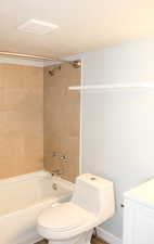 Full bath featuring toilet,  shower combination, and vanity