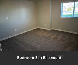 Spare room with dark carpet and baseboards