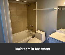 Full bath featuring bathing tub / shower combination, toilet, and vanity