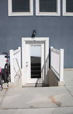 Entrance to property featuring stucco siding