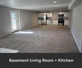Unfurnished living room with recessed lighting, carpet flooring, a sink, and baseboards