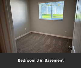 Spare room featuring carpet floors and baseboards