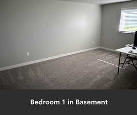 Unfurnished office with carpet floors and baseboards