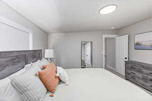 Carpeted bedroom with baseboards and visible vents