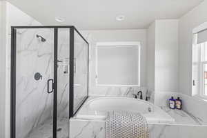 Bathroom with a garden tub, marble finish floor, a marble finish shower, and recessed lighting